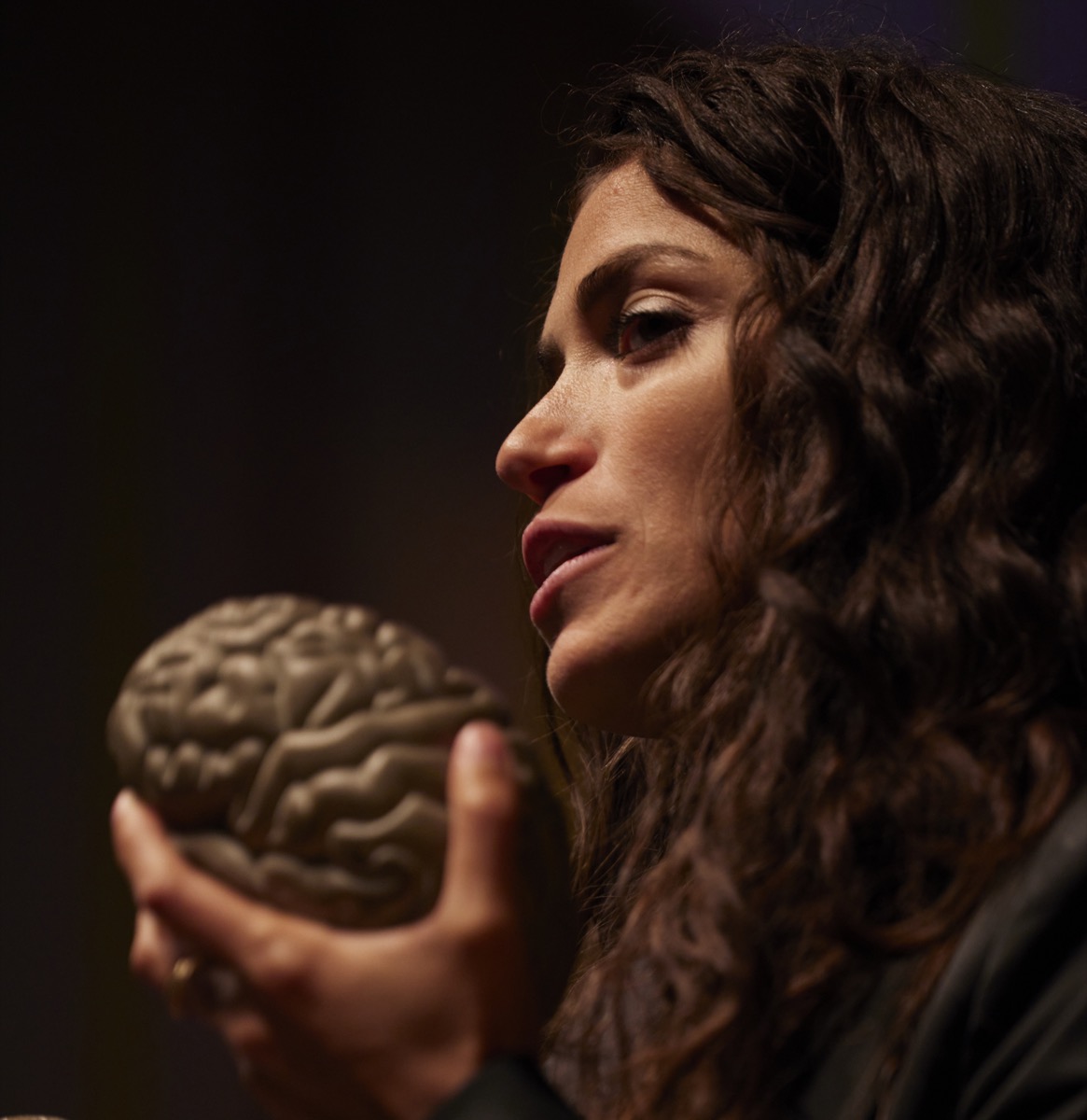 Fran holding a brain model while teaching